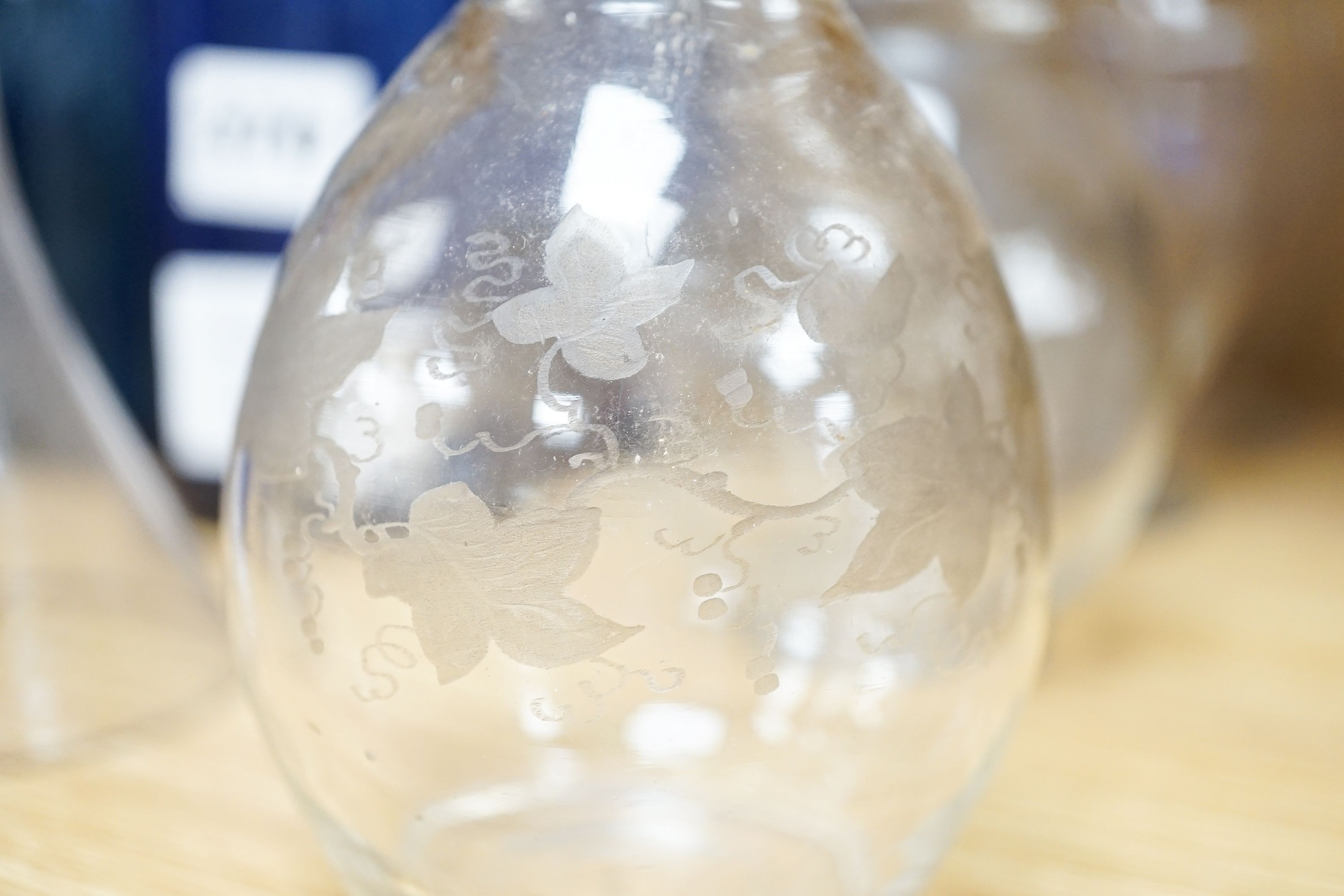 A Lalique frosted glass bird, etched Wedgwood ‘plant a tree ‘73’ glass, other etched glasses, decanters and blue glass pharmacy bottles